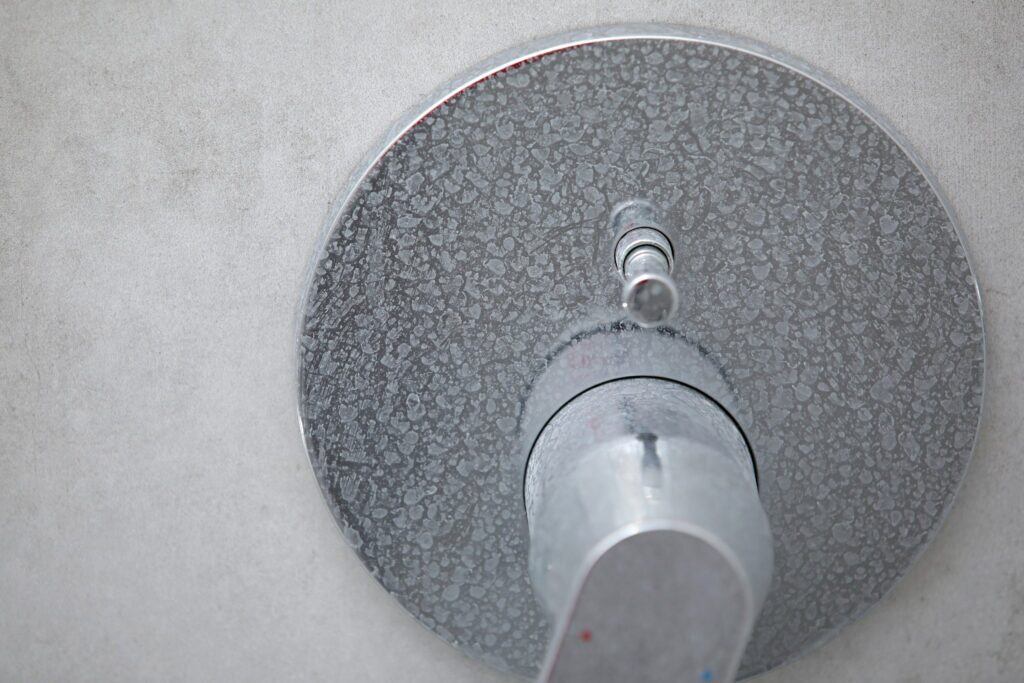 Shower handle with limescale buildup from hard water