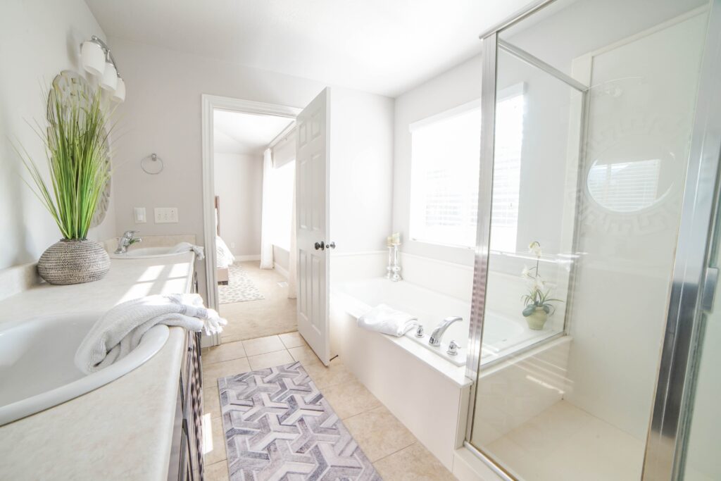 Newly installed bathtub, shower, and sink in a remodeled bathroom